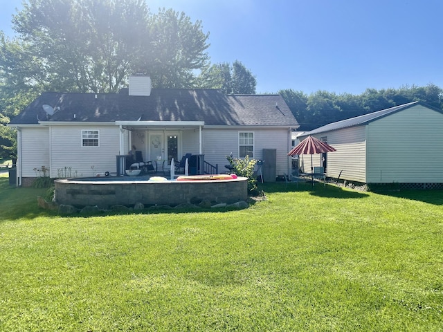 126 Kimberly St, Portland, TN 37148 - rear view of house with a lawn, a patio area, and a chimney