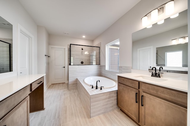 7274 Fairlawn Dr, Fairview, TN 37062 - bathroom featuring healthy amount of natural light, two vanities, a tile shower, and recessed lighting