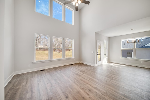 7274 Fairlawn Dr, Fairview, TN 37062 - unfurnished living room featuring ceiling fan, a chandelier, a high ceiling, and wood finished floors