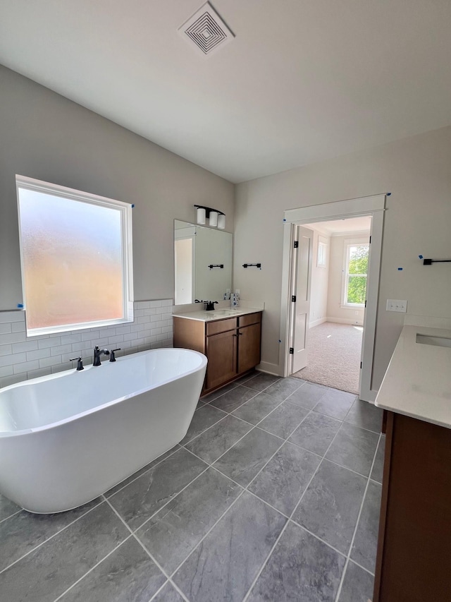 7274 Fairlawn Dr, Fairview, TN 37062 - full bathroom featuring vanity, a soaking tub, tile walls, tile patterned floors, and a wainscoted wall