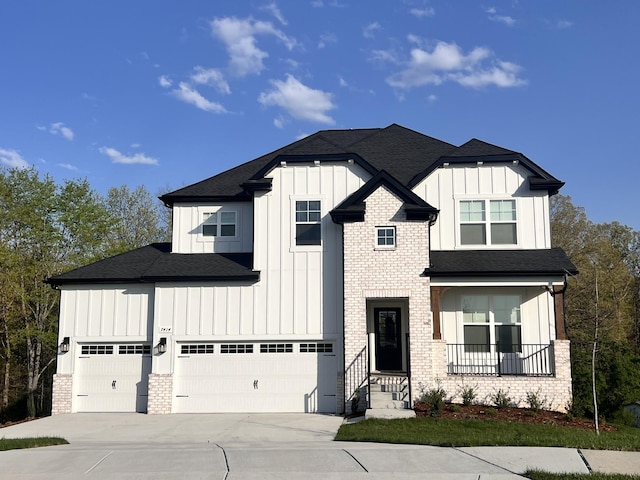 7274 Fairlawn Dr, Fairview, TN 37062 - view of front of home with board and batten siding, concrete driveway, an attached garage, and a shingled roof