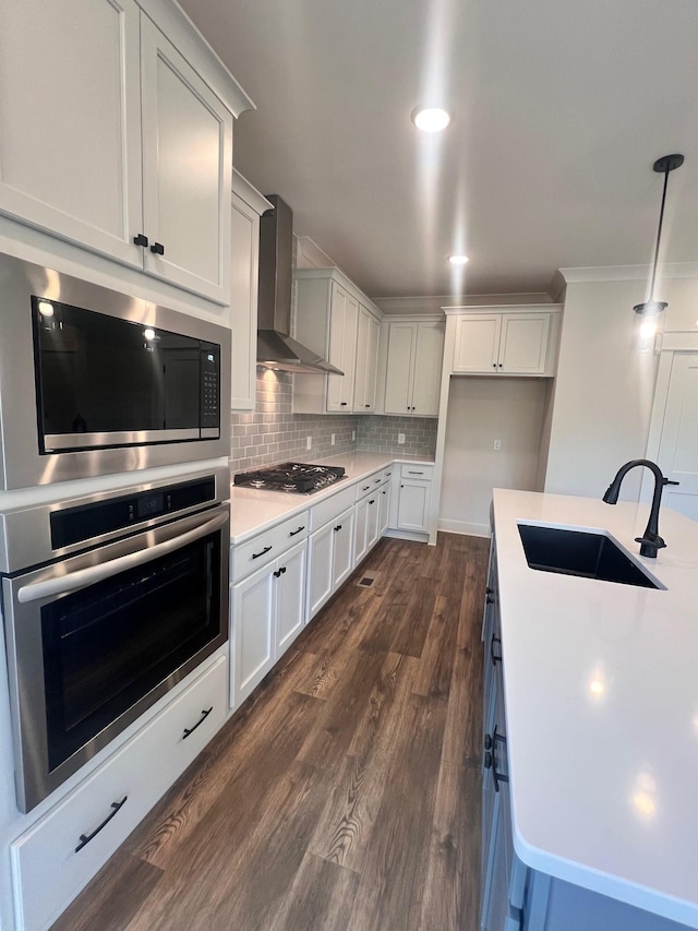 7274 Fairlawn Dr, Fairview, TN 37062 - kitchen featuring appliances with stainless steel finishes, wall chimney exhaust hood, light countertops, dark wood finished floors, and decorative backsplash