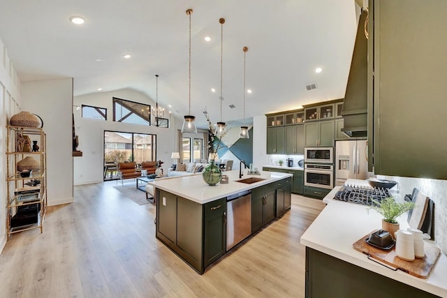 7235 Fairlawn Dr, Fairview, TN 37062 - kitchen featuring stainless steel appliances, light countertops, open floor plan, a kitchen island with sink, and light wood-type flooring
