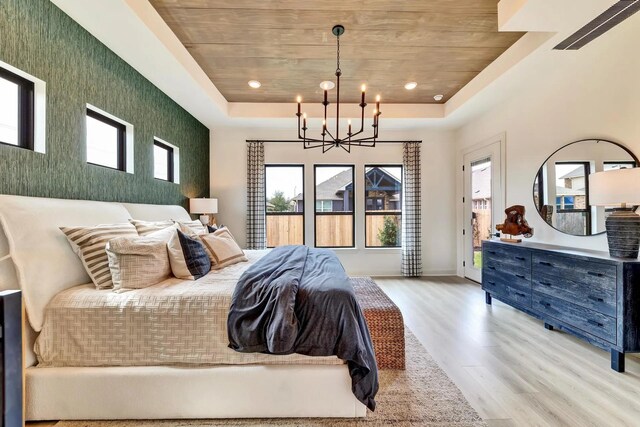 7235 Fairlawn Dr, Fairview, TN 37062 - bedroom featuring an accent wall, wood ceiling, wood finished floors, a tray ceiling, and a chandelier