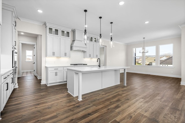 7253 Fairlawn Dr, Fairview, TN 37062 - kitchen with custom exhaust hood, a chandelier, ornamental molding, cooktop, and light countertops