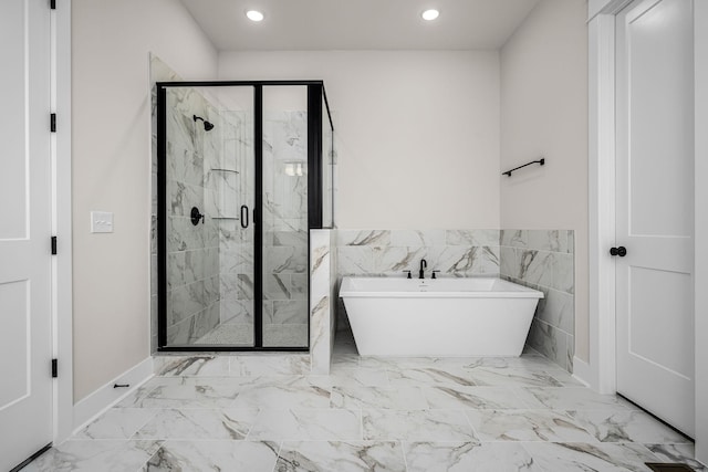 7253 Fairlawn Dr, Fairview, TN 37062 - full bathroom with a freestanding tub, a marble finish shower, recessed lighting, marble look tile flooring, and wainscoting