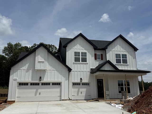 7253 Fairlawn Dr, Fairview, TN 37062 - modern inspired farmhouse with board and batten siding, a shingled roof, covered porch, and driveway