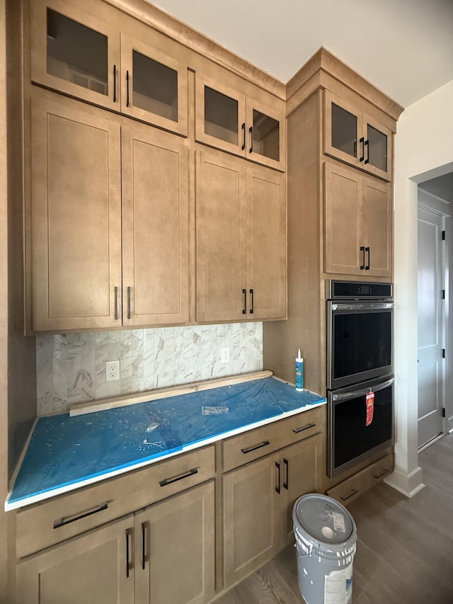 7253 Fairlawn Dr, Fairview, TN 37062 - kitchen featuring stainless steel double oven, decorative backsplash, dark wood finished floors, and glass insert cabinets