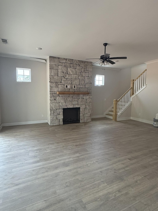 7253 Fairlawn Dr, Fairview, TN 37062 - unfurnished living room featuring stairs, wood finished floors, a fireplace, ceiling fan, and ornamental molding