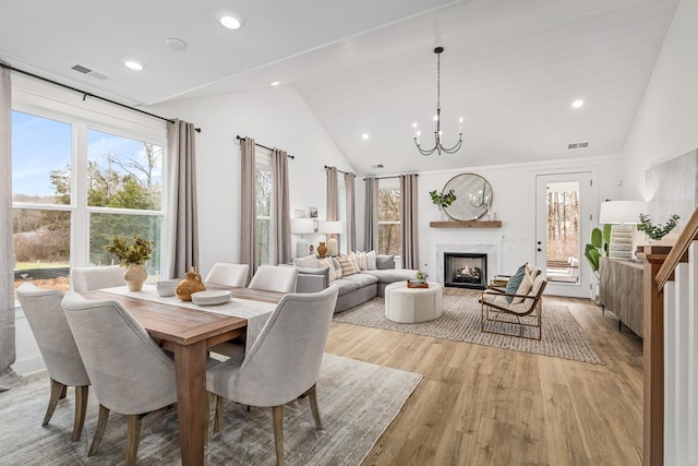 665 Conifer Dr, Spring Hill, TN 37174 - dining space with light wood finished floors, a chandelier, healthy amount of natural light, recessed lighting, and high vaulted ceiling