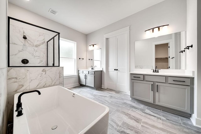 7267 Fairlawn Dr, Fairview, TN 37062 - bathroom with a freestanding tub, two vanities, a shower stall, and marble look tile flooring