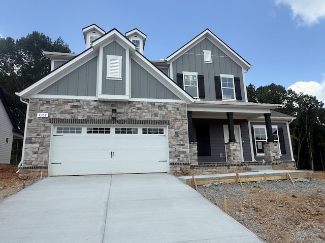 7267 Fairlawn Dr, Fairview, TN 37062 - craftsman house featuring board and batten siding, covered porch, driveway, and stone siding