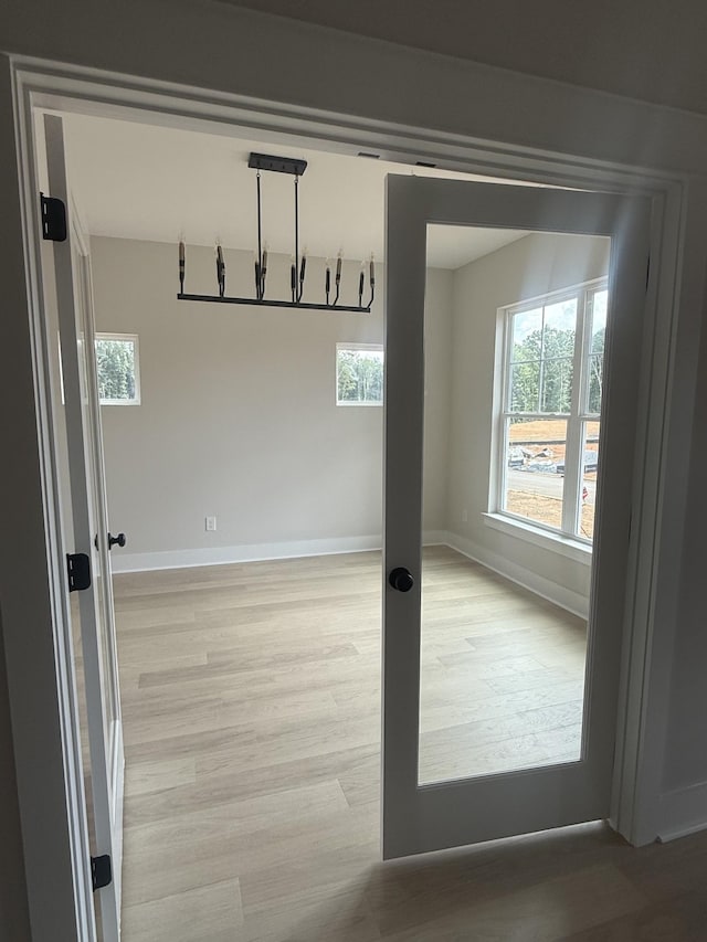 7267 Fairlawn Dr, Fairview, TN 37062 - empty room featuring light wood-type flooring, healthy amount of natural light, and a chandelier