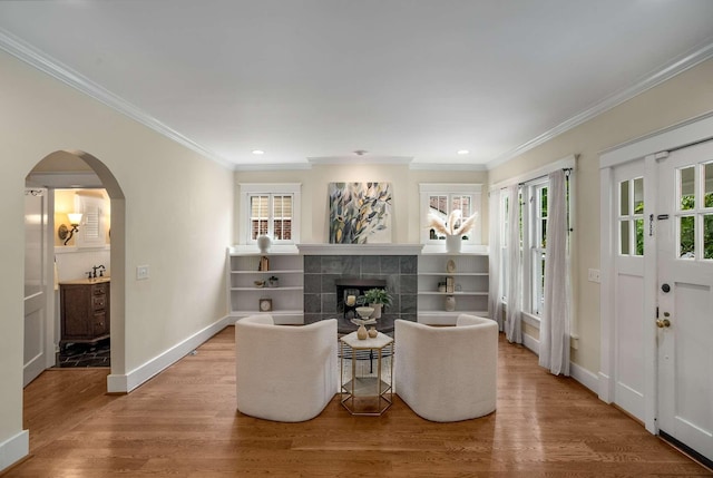 162 Woodmont Blvd, Nashville, TN 37205 - living room with wood finished floors, ornamental molding, arched walkways, a tile fireplace, and recessed lighting