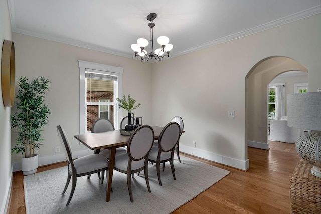 162 Woodmont Blvd, Nashville, TN 37205 - dining space featuring a chandelier, wood finished floors, arched walkways, and ornamental molding