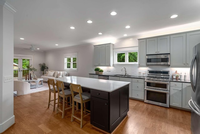 162 Woodmont Blvd, Nashville, TN 37205 - kitchen featuring stainless steel appliances, crown molding, tasteful backsplash, a center island, and open floor plan