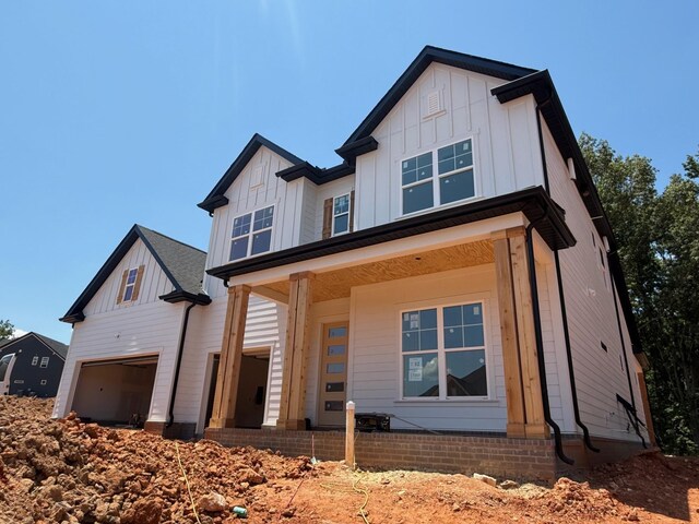 7263 Fairlawn Dr, Fairview, TN 37062 - modern inspired farmhouse featuring board and batten siding, covered porch, and a garage