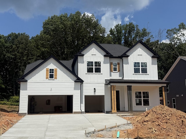 7263 Fairlawn Dr, Fairview, TN 37062 - modern inspired farmhouse featuring board and batten siding, covered porch, driveway, and a garage
