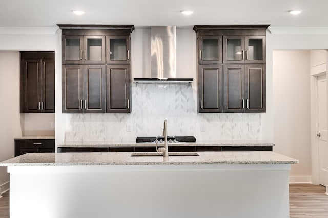 7266 Fairlawn Dr, Fairview, TN 37062 - kitchen with range hood, crown molding, light wood-style floors, dark brown cabinets, and light stone counters