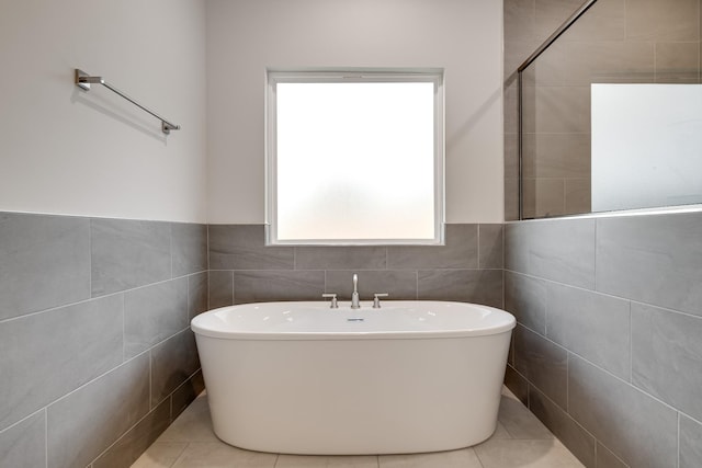 7266 Fairlawn Dr, Fairview, TN 37062 - full bathroom with a soaking tub, tile walls, wainscoting, and tile patterned flooring