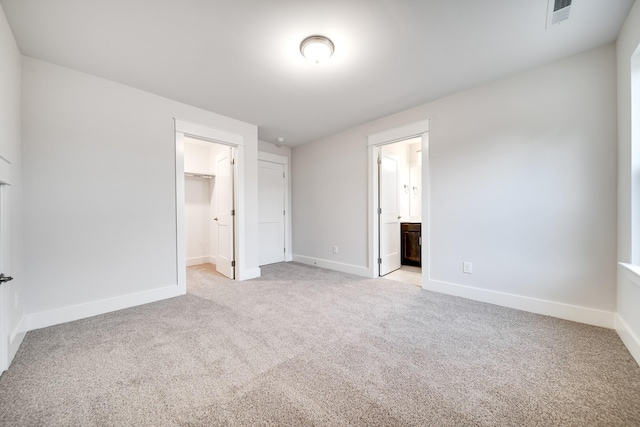 7266 Fairlawn Dr, Fairview, TN 37062 - unfurnished bedroom with light carpet, a spacious closet, and ensuite bathroom