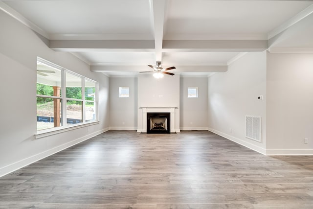 7266 Fairlawn Dr, Fairview, TN 37062 - unfurnished living room with plenty of natural light, a ceiling fan, beam ceiling, a fireplace with flush hearth, and wood finished floors