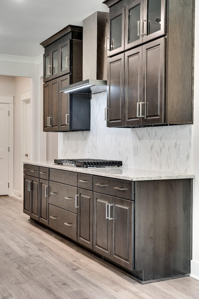 7266 Fairlawn Dr, Fairview, TN 37062 - kitchen with wall chimney exhaust hood, stainless steel gas cooktop, backsplash, and light wood-type flooring