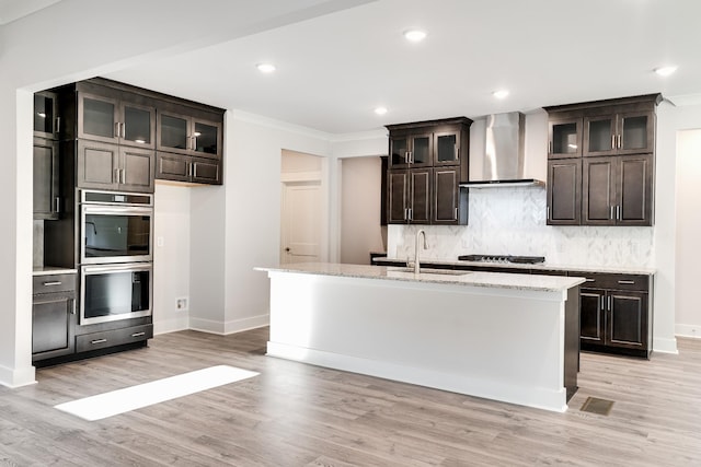 7266 Fairlawn Dr, Fairview, TN 37062 - kitchen with wall chimney exhaust hood, appliances with stainless steel finishes, crown molding, decorative backsplash, and light wood-type flooring