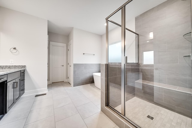 7266 Fairlawn Dr, Fairview, TN 37062 - full bathroom featuring vanity, a shower stall, a freestanding tub, tile patterned flooring, and tile walls