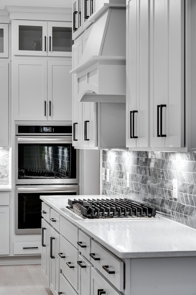 7233 Richvale Dr W, Fairview, TN 37062 - kitchen with appliances with stainless steel finishes, custom exhaust hood, light countertops, and backsplash