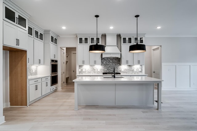 7233 Richvale Dr W, Fairview, TN 37062 - kitchen with crown molding, light countertops, stainless steel double oven, backsplash, and a center island with sink