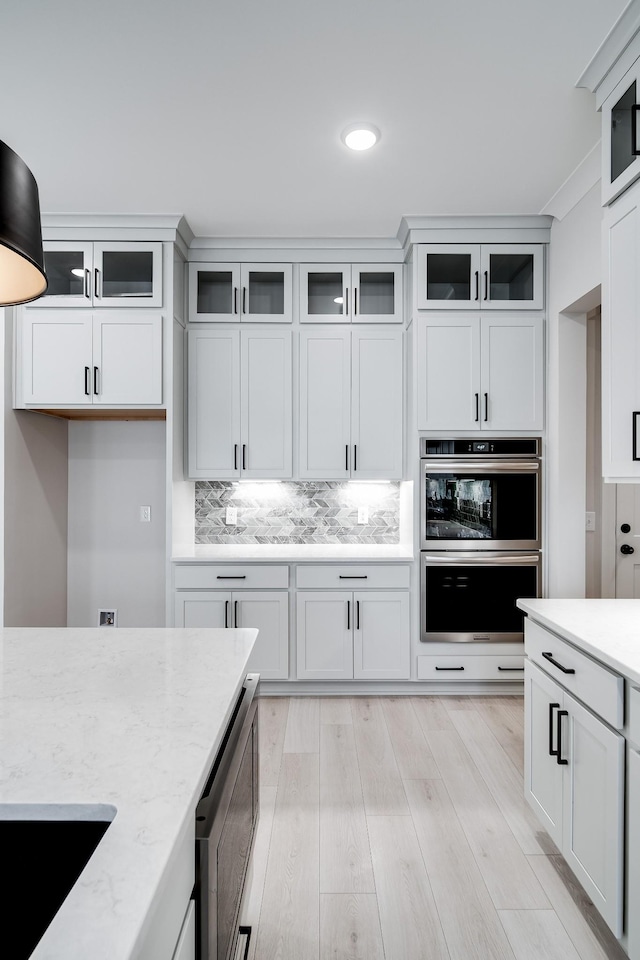 7233 Richvale Dr W, Fairview, TN 37062 - kitchen featuring stainless steel appliances, light stone counters, decorative backsplash, white cabinets, and recessed lighting