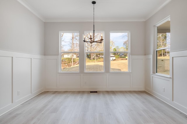 7233 Richvale Dr W, Fairview, TN 37062 - unfurnished dining area featuring a decorative wall, a chandelier, healthy amount of natural light, light wood-style floors, and wainscoting