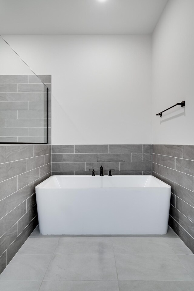 7233 Richvale Dr W, Fairview, TN 37062 - bathroom featuring tile walls, a soaking tub, and tile patterned floors