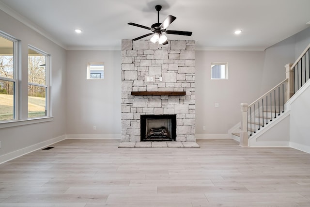 7233 Richvale Dr W, Fairview, TN 37062 - unfurnished living room featuring ornamental molding, stairway, ceiling fan, wood finished floors, and a stone fireplace