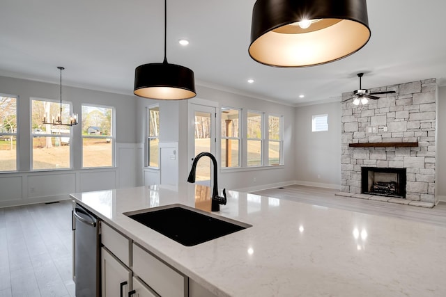 7233 Richvale Dr W, Fairview, TN 37062 - kitchen with a chandelier, hanging light fixtures, a ceiling fan, light stone counters, and ornamental molding