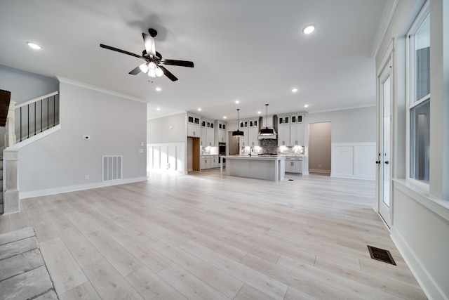 7233 Richvale Dr W, Fairview, TN 37062 - unfurnished living room featuring ceiling fan, ornamental molding, light wood-type flooring, recessed lighting, and stairway