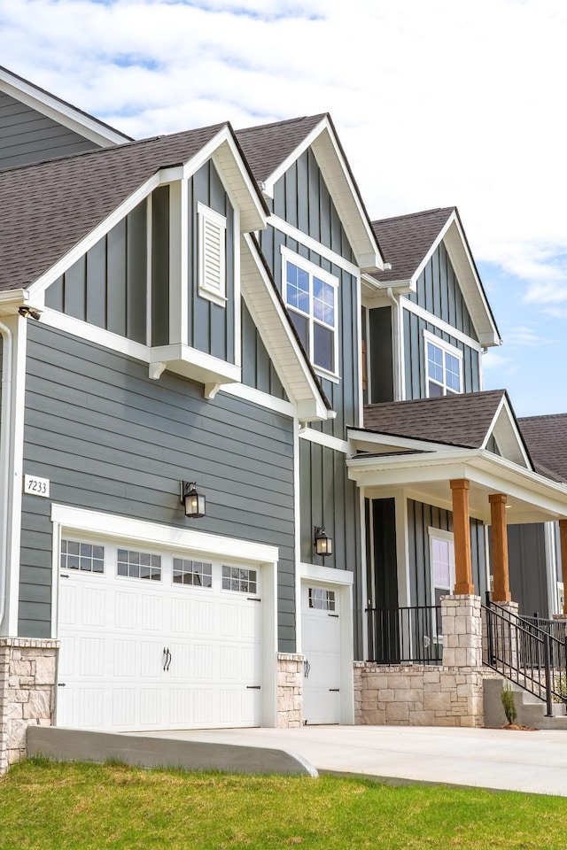 7233 Richvale Dr W, Fairview, TN 37062 - craftsman house featuring board and batten siding, a shingled roof, a garage, and stone siding
