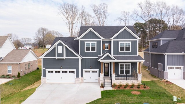 7233 Richvale Dr W, Fairview, TN 37062 - craftsman-style home featuring a porch, stone siding, driveway, and an attached garage