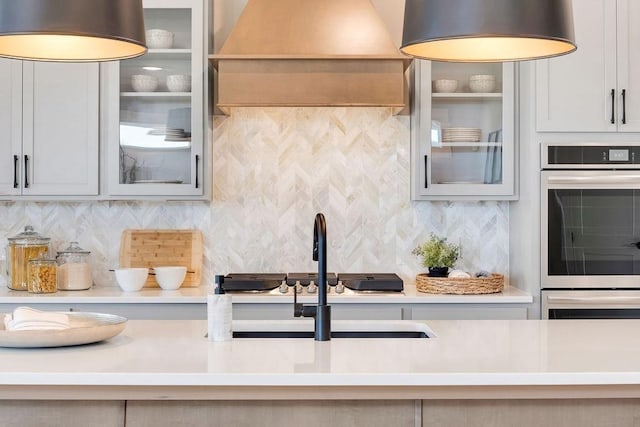 7428 Twill Heights Loop W, Fairview, TN 37062 - kitchen with tasteful backsplash, stainless steel double oven, glass insert cabinets, and light countertops