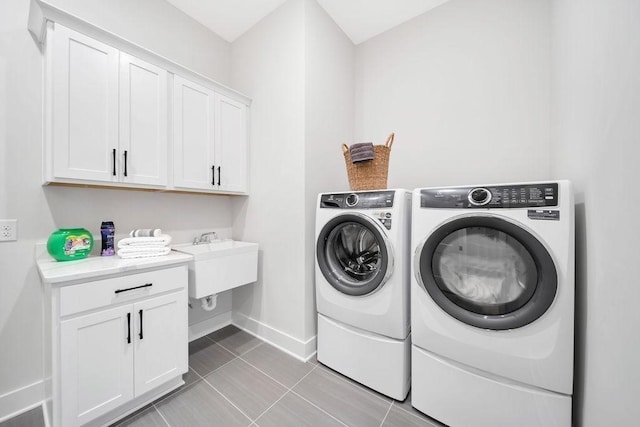 7428 Twill Heights Loop W, Fairview, TN 37062 - laundry room with washer and clothes dryer, cabinet space, and light tile patterned flooring