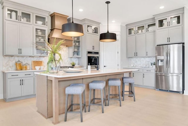 7428 Twill Heights Loop W, Fairview, TN 37062 - kitchen with stainless steel refrigerator with ice dispenser, backsplash, a kitchen breakfast bar, light countertops, and a kitchen island with sink