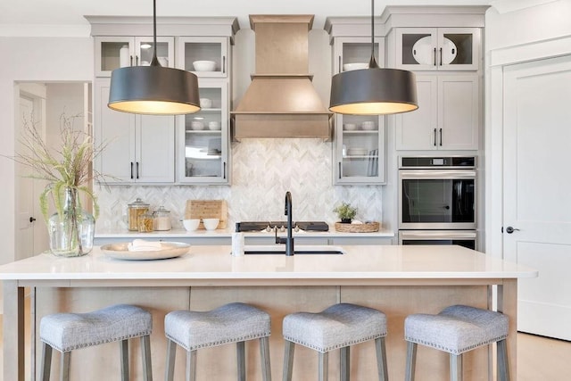 7428 Twill Heights Loop W, Fairview, TN 37062 - kitchen with premium range hood, stainless steel double oven, backsplash, a kitchen breakfast bar, and pendant lighting