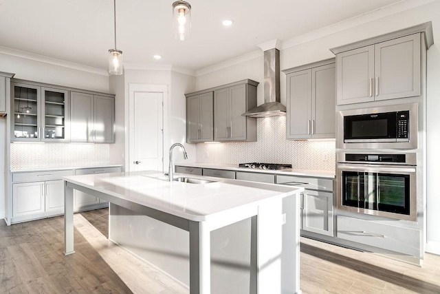 7262 Fairlawn Dr, Fairview, TN 37062 - kitchen with stainless steel appliances, wall chimney range hood, gray cabinets, ornamental molding, and light countertops