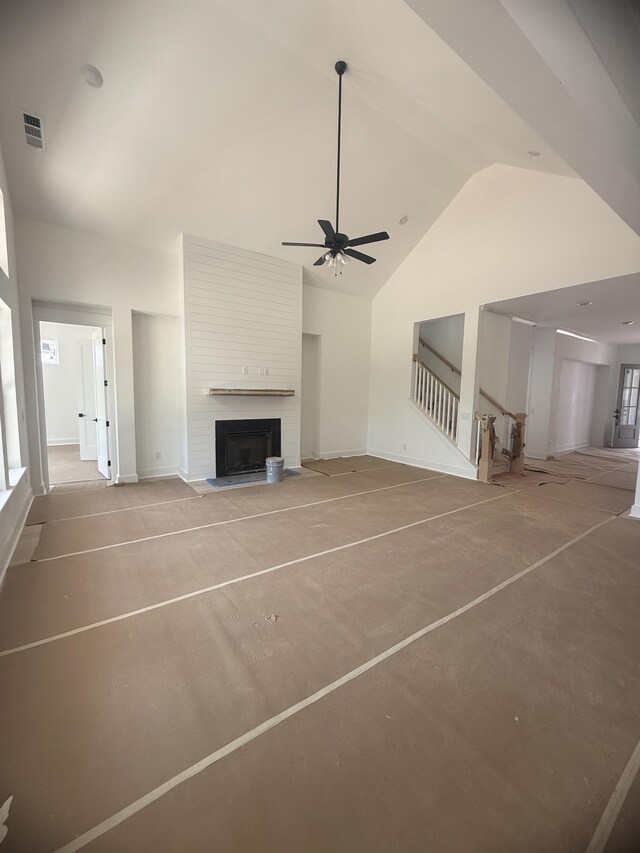 7262 Fairlawn Dr, Fairview, TN 37062 - unfurnished living room featuring high vaulted ceiling, a ceiling fan, stairs, and a large fireplace
