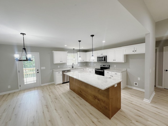 307 Ledgeview Dr, Shelbyville, TN 37160 - kitchen featuring appliances with stainless steel finishes, light wood-style flooring, recessed lighting, a center island, and white cabinetry