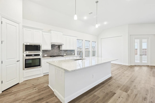 7261 Fairlawn Dr, Fairview, TN 37062 - kitchen with appliances with stainless steel finishes, light wood-style floors, vaulted ceiling, backsplash, and white cabinets