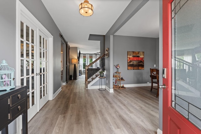 1301 Drury Ln, Mount Juliet, TN 37122 - foyer entrance featuring light wood-type flooring, stairs, a barn door, and french doors