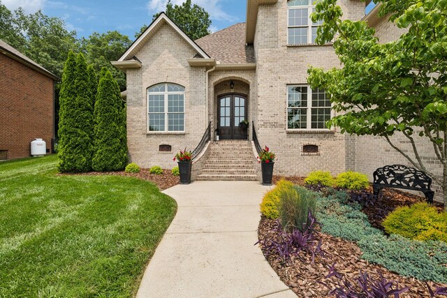 624 Twin View Dr, Murfreesboro, TN 37128 - view of front facade featuring french doors, brick siding, a front yard, and a shingled roof