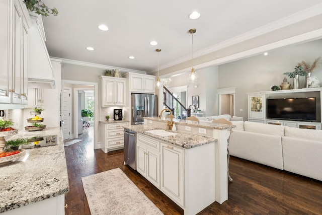 624 Twin View Dr, Murfreesboro, TN 37128 - kitchen featuring appliances with stainless steel finishes, ornamental molding, open floor plan, white cabinets, and light stone countertops